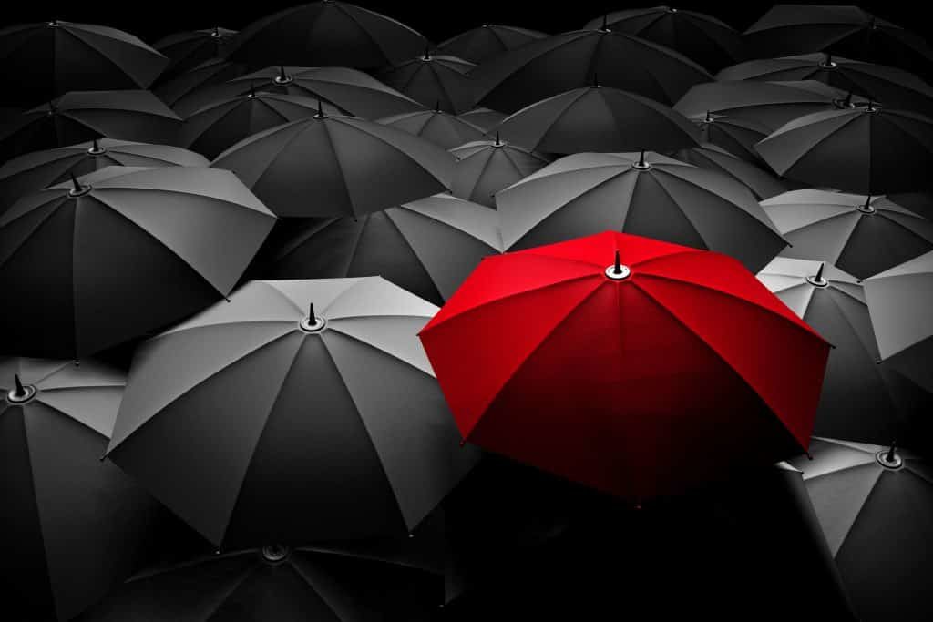 People hold umbrella and one of them is red.